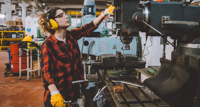 young woman working on a milling machine