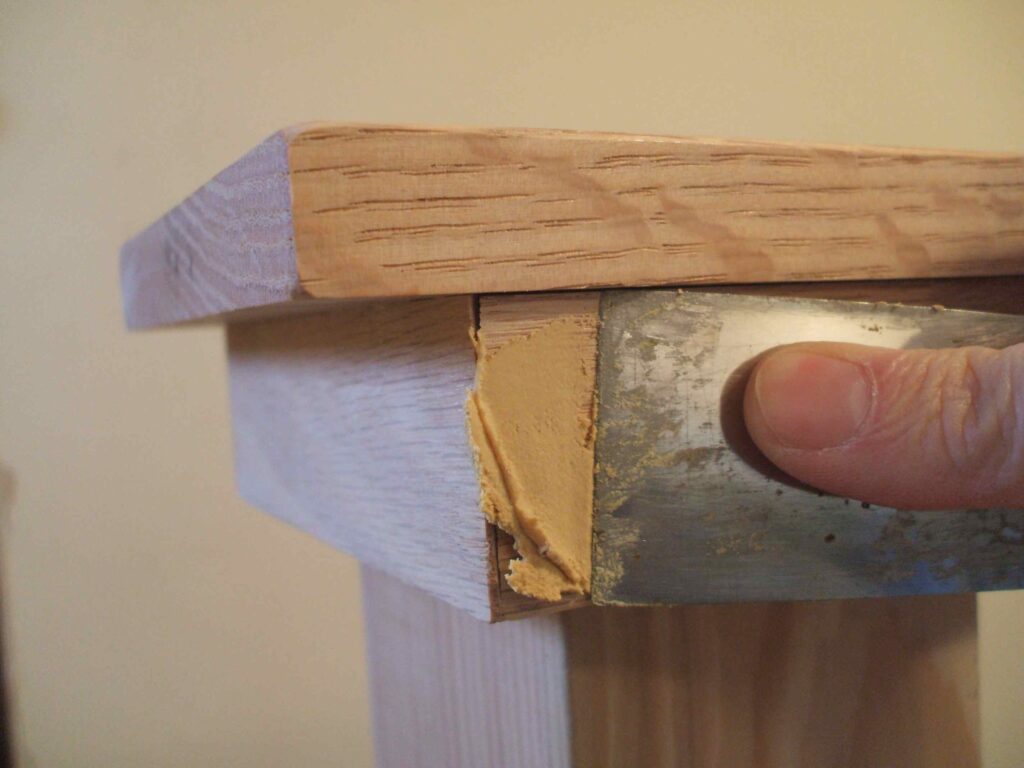 applying a wood filler to fix rotten wood