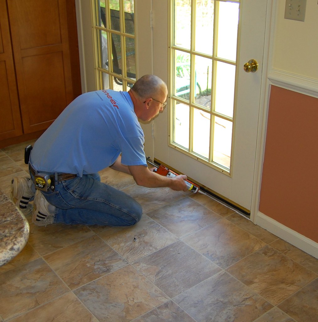 caulking around a wooden door frame to prevent wood rot