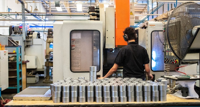 woman standing behind a cnc machine