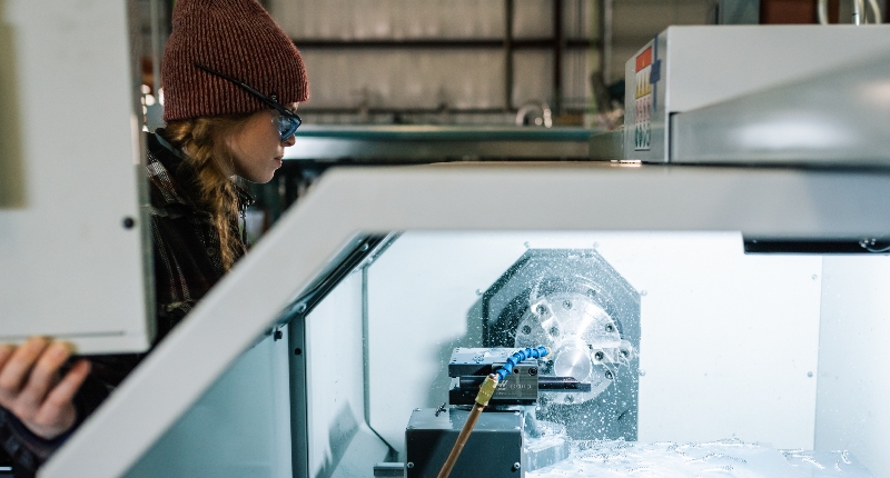 woman operating a cnc lathe machine